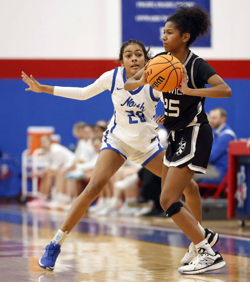 St. Charles North's Sydney Johnson (20) pressures Fenwick's Eleanor Gibson (25) during the Dundee-Crown High School 41st Annual Komaromy Classic Friday, Dec. 27, 2024 in Carpentersville.