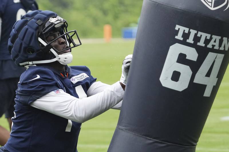 Chicago Bears wide receiver Olamide Zaccheaus hits a blocking dummy during NFL football practice at Halas Hall in Lake Forest, Ill., Wednesday, June 4, 2025. (AP Photo/Nam Y. Huh)