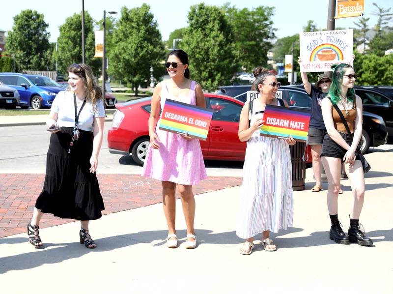 State Sen. Karina Villa (second from left) joins supporters, as well as a pair of onlookers with an opposing viewpoint, to raise the Pride flag in Batavia in honor of June being Pride Month.