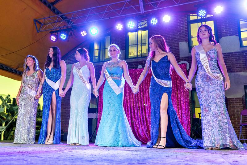 Contestants in the 2025 Miss Amboy pageant join hands as the judges make their picks Thursday, Aug. 21, 2025.
