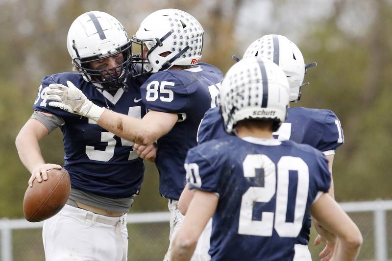 Cary-Grove's Nicholas Hissong, left, celebrates his touchdown against Crystal Lake Central with teammates during their playoff football game at Cary-Grove High School on Saturday, Nov. 13, 2021 in Cary.  Cary-Grove beat Crystal Lake Central 42-21 and will advance to meet Lake Forest next week.