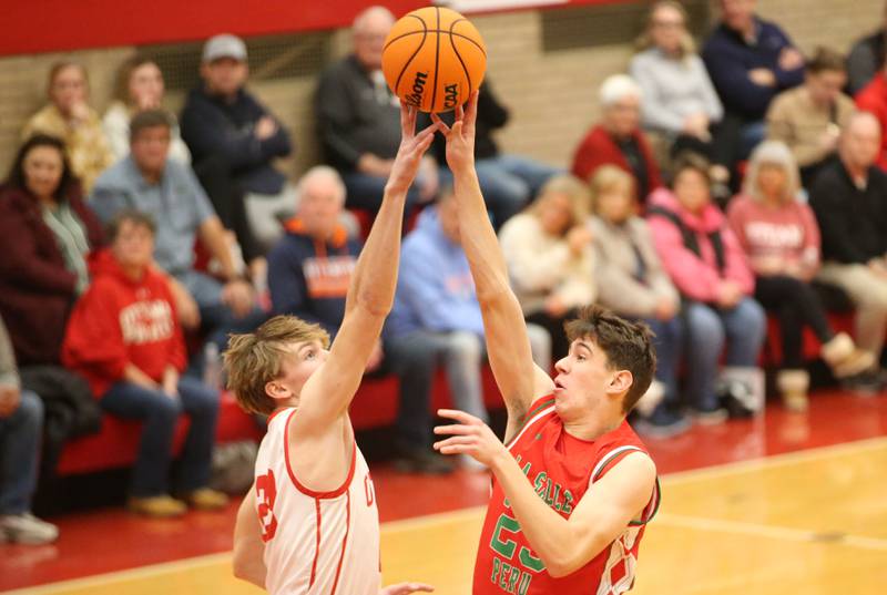 Ottawa's Owen Sanders gets a piece of L-P's Nick Olivero's shot on Friday, Jan. 10, 2024 in Kingman Gym at Ottawa High School.