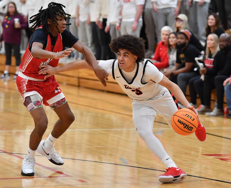 Benet’s Jayden Wright drives past Marist’s Torrence Tate during a game on Friday, Dec. 13, 2024 at Benet Academy in Lisle.