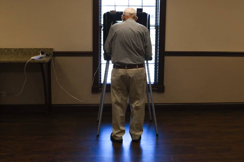 A voter fills out their ballot on Tuesday, April 6, 2021, at Blackburn-Gingrich-Sonntag Funeral Home in Joliet, Ill.