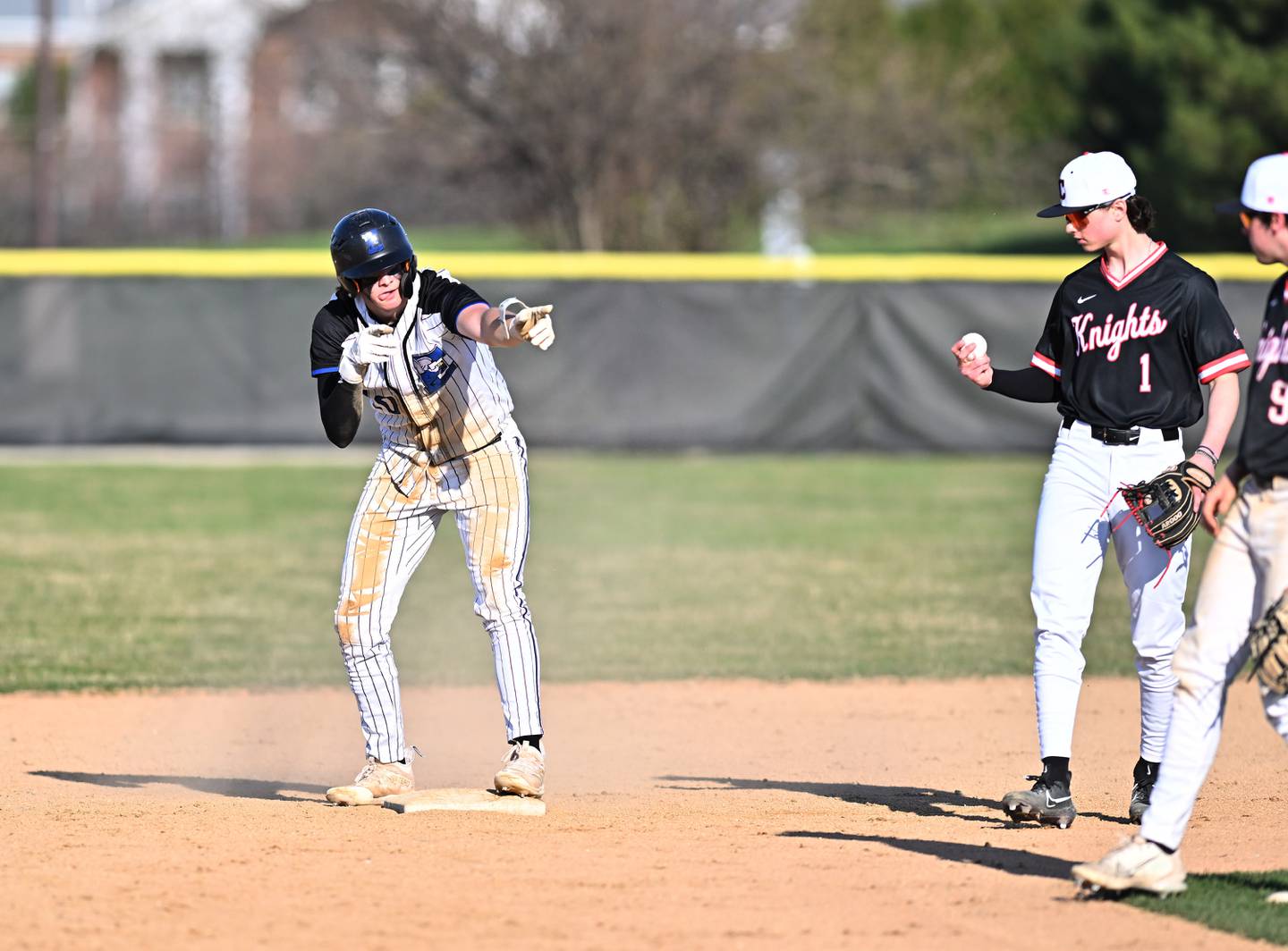Lincoln-Way East's Zach Kwasny celebrates after making it to second base during the conference game on Monday, April. 10, 2023, at Frankfort.
