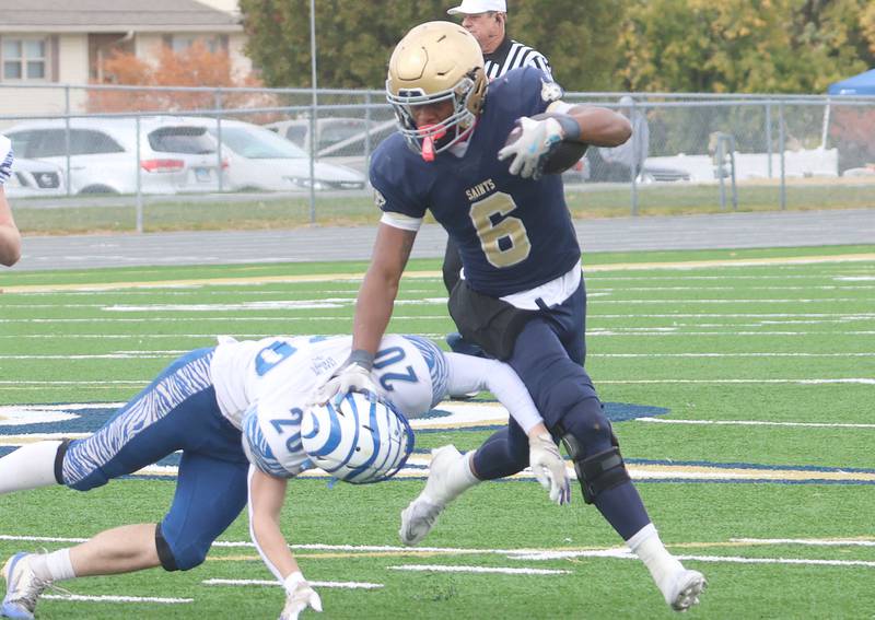 Central Catholic's Valshun Powe shoves Princeton's Jace Weyer to the turf on a run drring the Class 3A playoffs on Saturday, Nov. 1, 2025 at Central Catholic High School in Bloomington.