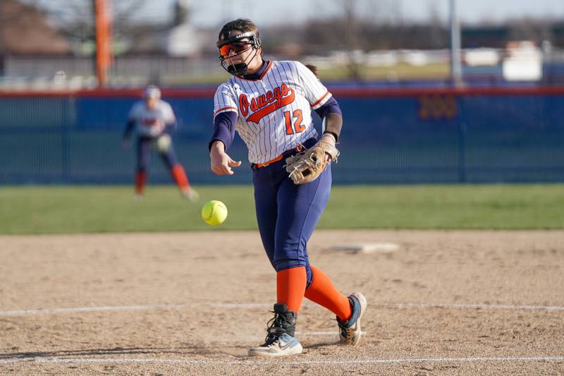 Oswego’s Aubriella Garza (12) delivers a pitch against Downers Grove South during a softball game at Oswego High School on Tuesday, March 19, 2024.