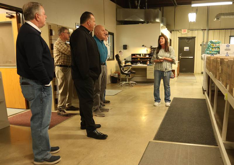 Illinois Valley Food Pantry executive director Mary Jo Credi leads Utica Knights of Columbus members on a tour of the Illinois Valley Food Pantry on Tuesday, April 28, 2026 in Peru.