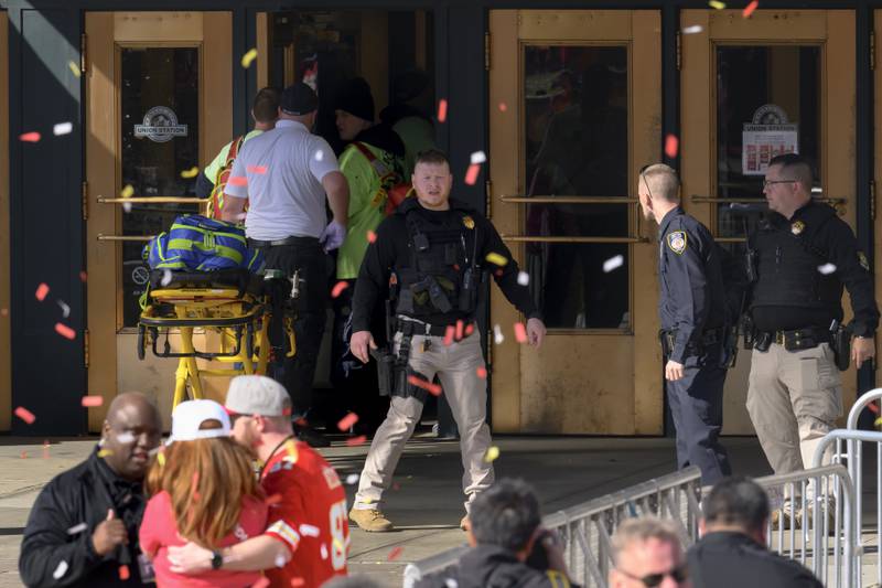 Emergency personnel, left, take a stretcher into Union Station following a shooting at the Kansas City Chiefs NFL football Super Bowl celebration in Kansas City, Mo., Wednesday, Feb. 14, 2024. Multiple people were injured, a fire official said.