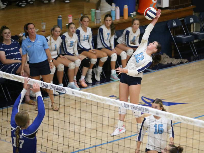 Marquette's Kinley Rick spikes the ball past Newark's Zoey Carlson on Wednesday, Aug. 27, 2025 in Bader Gymnasium.