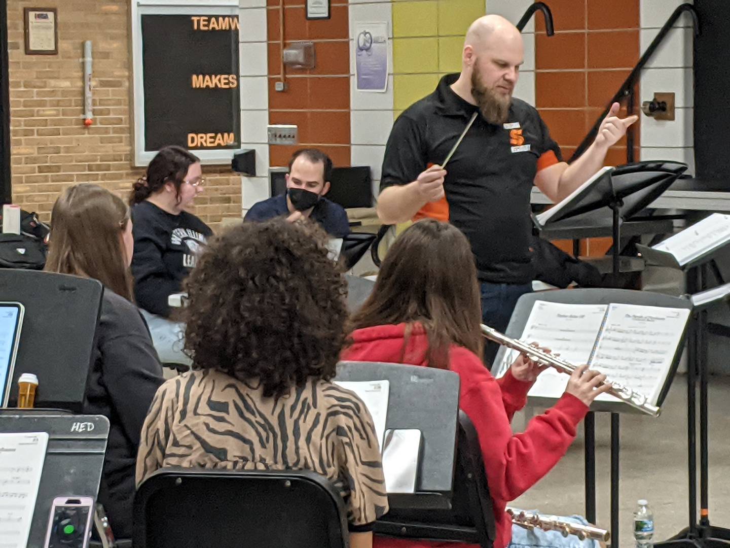 Justin Heinekamp, director of bands and district music coordinator for Sandwich CUSD 430, directs the pit orchestra during a March 7 rehearsal for "Cinderella."