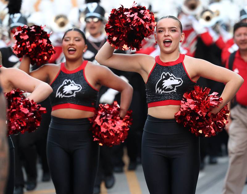 Members of the Northern Illinois University dance team lead the marching band down Lincoln Highway in the parade Thursday, Oct. 2, 2025, during the Huskie Homecoming Block Party in downtown DeKalb.