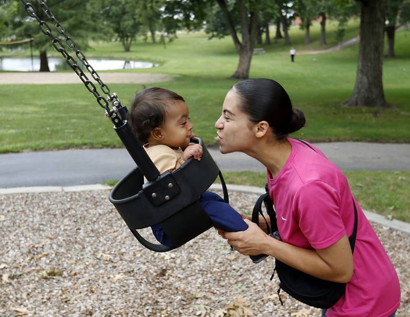 Gisselle Ruiz-Chimon interacts with her son, Levi, 1, while swinging on Thursday, Aug. 29, 2024, at the Cole Playground in Deicke Park in Huntley. The Huntley Park District is asking residents to approve a $18 million bond referendum on the November 5, 2024, general election ballot to improve, equip and maintain the parks and facilities.