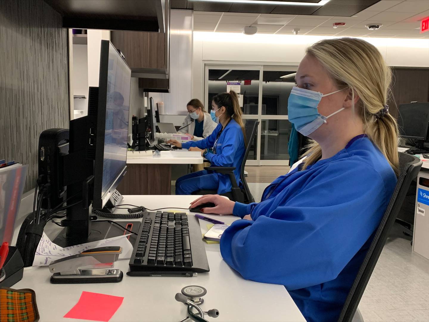 Elizabeth Coop right, Jocelyn Rodriguez, middle, and Christina Larson, back, work on patient care plans in the team station of the Medical Surgical Observation Unit at Northwestern Medicine McHenry Hospital on Monday, Dec. 13, 2021.