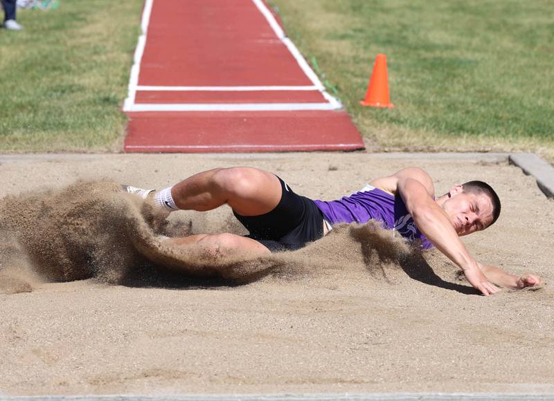 Dixon’s Owen Belzer lands hard during his attempt at the long jump Wednesday, May 20, 2026, during the Class 2A boys track sectional at Rochelle High School.