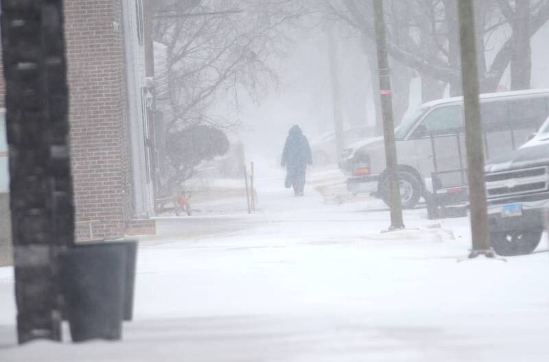 A pedestrian walks through the snow on Wednesday, Feb. 12, 2025 downtown Spring Valley.