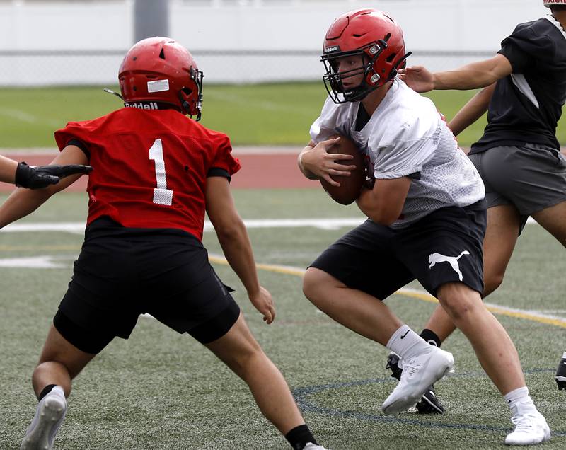 Huntley's Haiden Janke runs with the ball during the first day of football practice Monday, August 7, 2023, at the Huntley High School’s Red Raider Stadium.