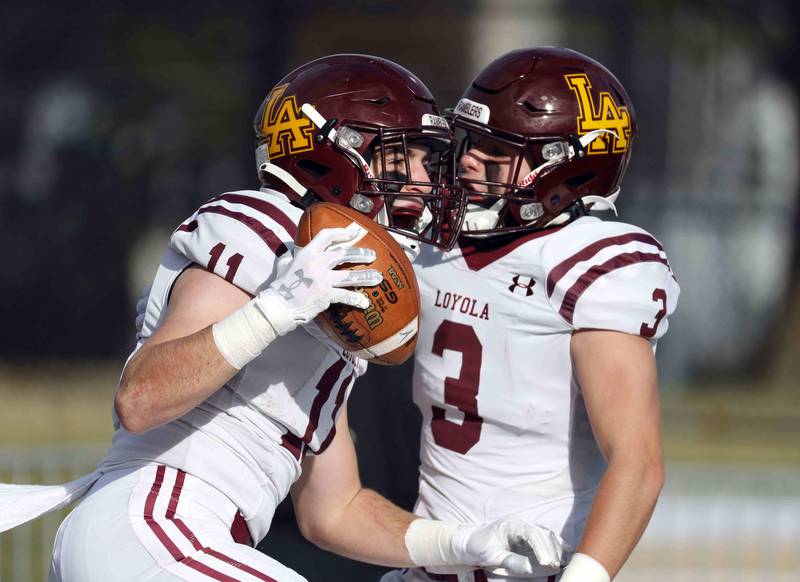 Loyola's Corey Larsen (11) celebrates his touchdown with teammate Quinn Foley (3) during the IHSA Class 8A semifinal football game Saturday November 19, 2022 in Elmhurst.
