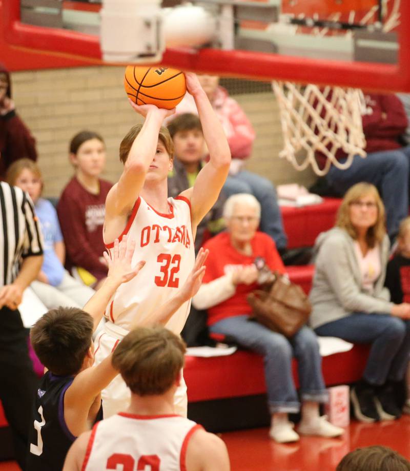 Ottawa's Aric Threadgil shoots a jump shot over Plano's Vinny Cesario during the Dean Riley Shootin' The Rock Thanksgiving Tournament on Tuesday, Nov. 26, 2024 in Kingman Gym at Ottawa High School.