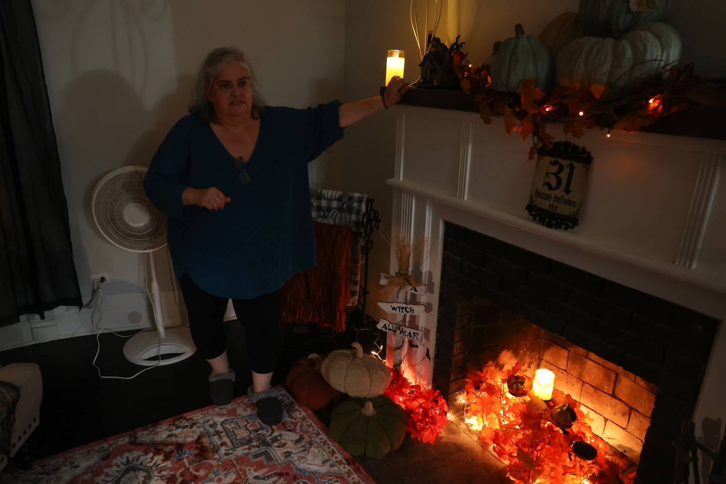 Mary Lou Wahlstrom stands in the small parlor where she claims to have seen a ghostly figure standing that she believes is Frank Shaver Allen, the original architect, on Saturday, Oct. 7, 2023 in Joliet