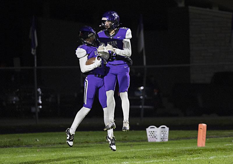 Dixon’s Cort Jacobson and Cullen Shaner celebrate a TD against North Boone Friday, Oct. 20, 2023 in Dixon.