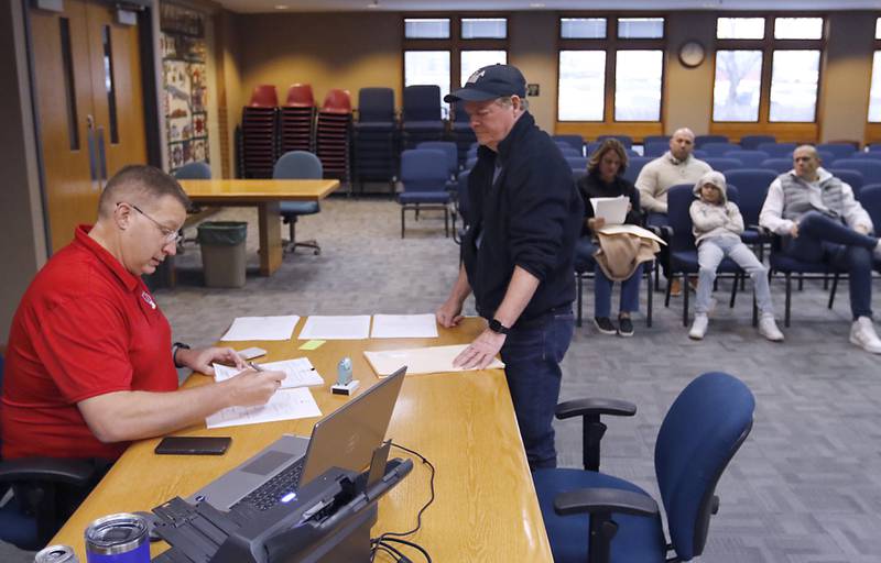 Alderman Frank McClatchey files his paperwork to run for another term representing Ward 3 on Tuesday, Nov. 12, 2024, with McHenry Deputy Clerk Monte Johnson during first day of filing for the Consolidated Election on April 1, 2025.
