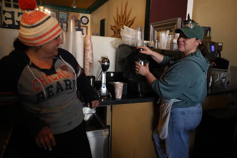 Sisters Amber Duffy watches as Hope Shelby makes a warm beverage at their family owned Jitters Coffee House in downtown Joliet on Friday, Jan 23, 2026.