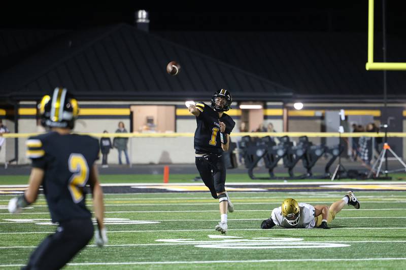 Herscher's Tanner Jones throws a pass after evading a Bishop McNamara defender during the Tigers 45-28 loss to the Fightin' Irish on Friday, Sept. 5, 2025.