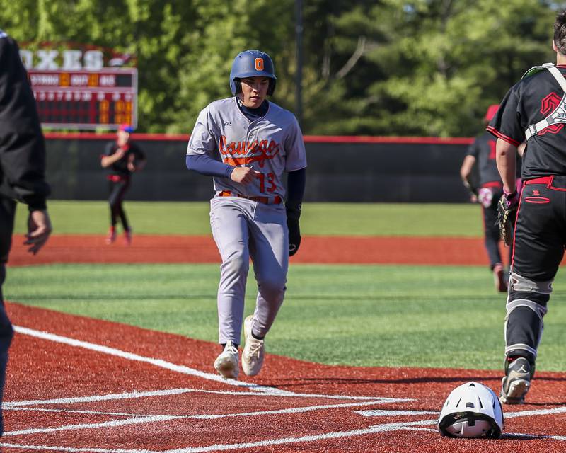 Oswego's Bryson Norwood (13) scores a run during baseball game between Oswego at Yorkville. Thursday, May 8, 2025 in Yorkville.