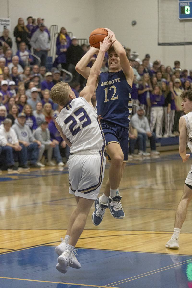 Denver Trainor of Marquette High School gets a shot off against Serena's Tanner Faivre during the IHSA Class 1A boys basketball championship at Serena High School on February 23, 2024.