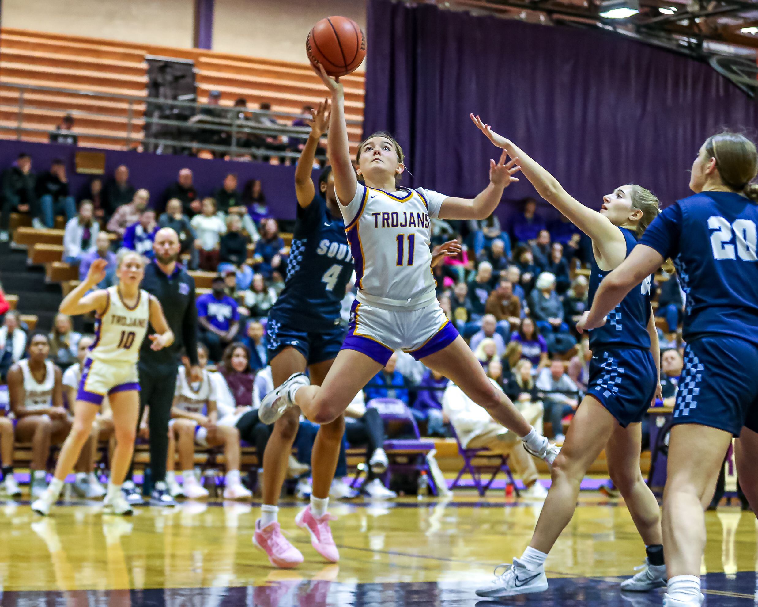 Downers Grove North's Abby Gross (11) puts up a shot during girls basketball game between Downers Grove South at Downers Grove North. Dec 16, 2023.