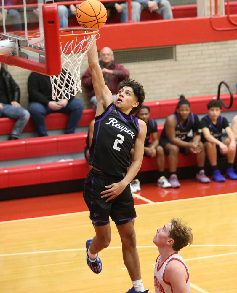 Plano's Gabe Steele runs in for a layup as Ottawa's Evan Snook defends during the Dean Riley Shootin' The Rock Thanksgiving Tournament on Tuesday, Nov. 26, 2024 in Kingman Gym at Ottawa High School.