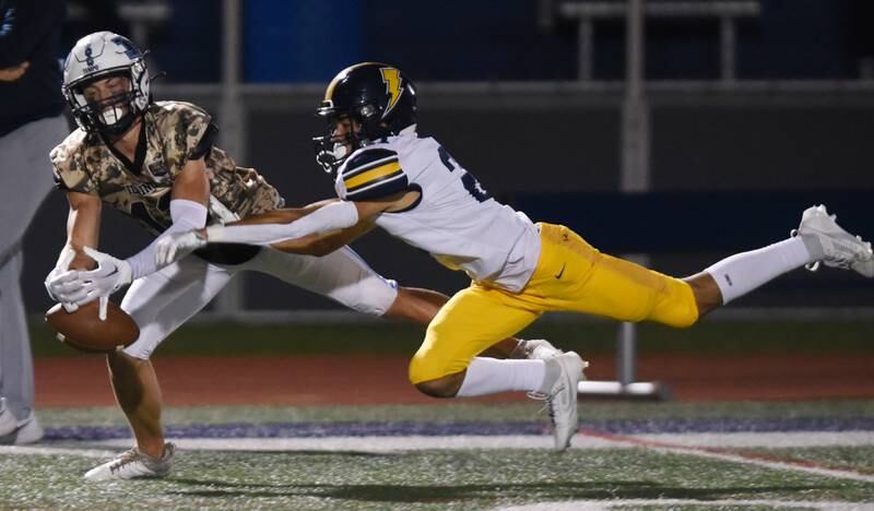 Joe Lewnard/jlewnard@dailyherald.com
Prospect’s Nicholas Carlucci, left, is unable to hang onto the ball as Glenbrook South's Joaquin Williams breaks up the pass during Thursday’s game in Mount Prospect.