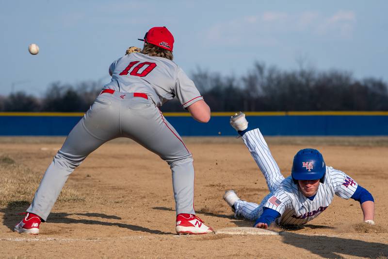 Marmion's Luke O'Connor (4) dives back to first to avoid a pick-off attempt by Yorkville during a baseball game at Marmion High School in Aurora on Tuesday, Mar 28, 2023.