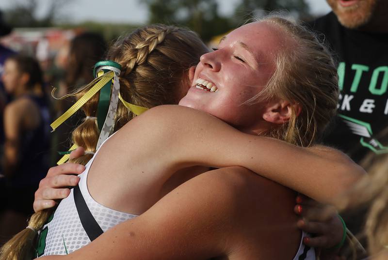 Crystal Lake South’s Abby Machesky is hugged by  Olivia Pinta after they won the  4 x 100 meter relay during the Huntley IHSA Class 3A Girls Sectional Track and Field Meet on Wednesday, May 8, 2024, at Huntley High School.