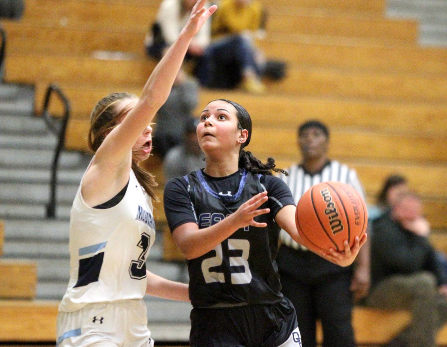 Oswego East’s Cami Phillips (23) ges a shot up past Downers Grove South’s Emily Petring during a game in the 11th Annual Thanksgiving Tournament at York Community High School in Elmhurst on Monday, Nov. 14, 2022.