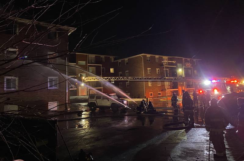 Firefighters from multiple agencies deploy hoses from the parking lot on Sunday, Dec. 22, 2024, at 1024 W. Hillcrest Drive, where a fire broke out inside an apartment complex. Multiple residents were impacted, authorities said.