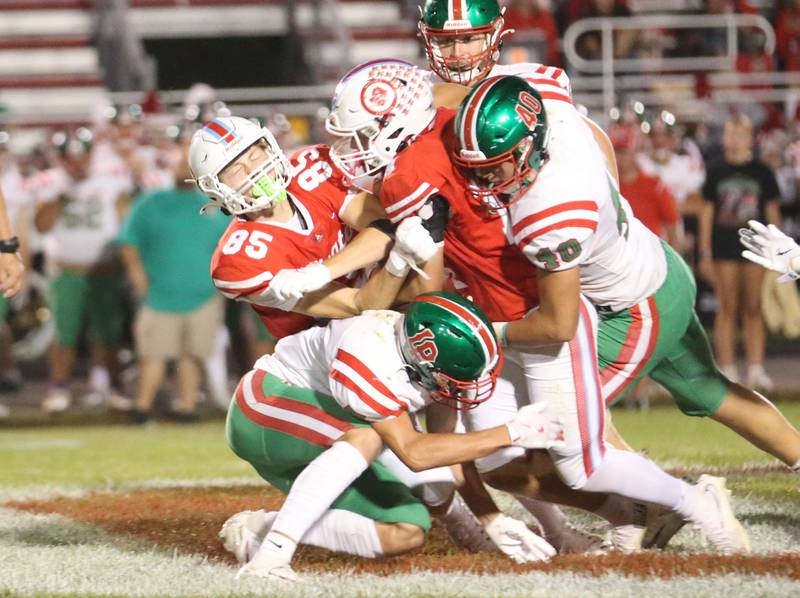 Ottawa's Dane Carretto (85) helps block for teammate Archer Cechowiz (middle) as L-P players Regan Doerr (bottom) Nick Hachenberger (middle) and Beau Lawrence (top) take him down on Friday, Sept. 12, 2025 at King Field.