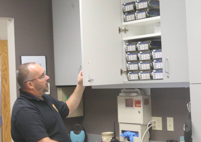 La Salle County Corner Rich Ploch opens a cabinet door with storage materials at the La Salle County Forensic Center on Wednesday, Aug. 30, 2023 in Oglesby.