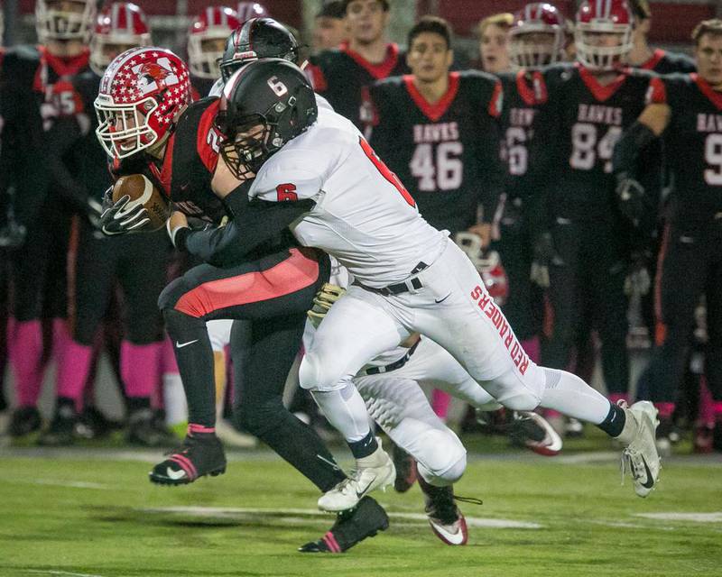 Huntley linebacker Michael Talesky (6) tackles Maine South running back Danny Wolf (21) in the second quarter of an IHSA Playoff Class 8A first-round football game at Maine South High School, Park Ridge, Ill., Friday, Oct. 26, 2018. Huntley lost, 55-14.