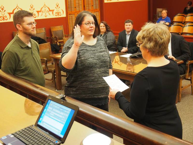 County Board member Elizabeth Flowers is joined by her boyfriend, Edward Mara, as she is sworn into office for another term Monday evening. Flowers was named Forest Preserve District secretary during the board's organizational meeting.