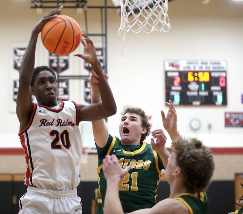 Huntley's Isaiah Onu grabs a rebound in front of Crystal Lake South's Ryan Morgan during a Fox Valley Conference boys basketball game on Wednesday, Dec. 10, 2025, at Huntley High School.