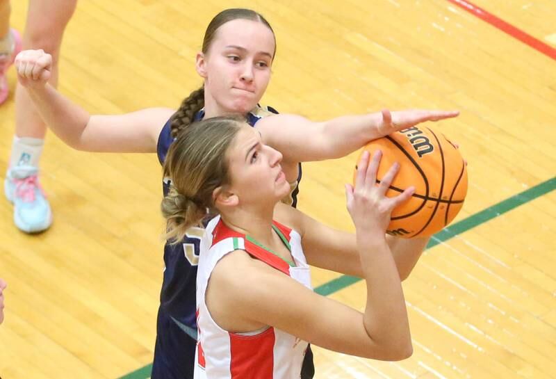 Marquette's Chloe Larson blocks Kelsey Frederick's shot on Saturday, Jan. 4, 2025 in Sellett Gymnasium at L-P High School.