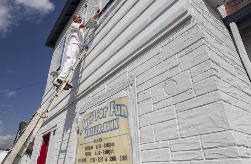 Michael Vickers volunteers to help paint the Just For Fun Roller Rink in McHenry. The roller rink is planning a grand reopening event Saturday, after the community donated their time and resources to help make critical repairs to the facility.