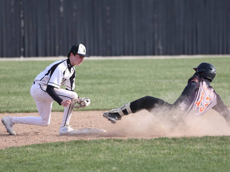 Sycamore's Jack Montani waits to apply the tag as Freeport's Ben Summers slides into second Tuesday, April 7, 2026, during their game at the Sycamore Community Sports Complex. Summers was ruled safe on the play.