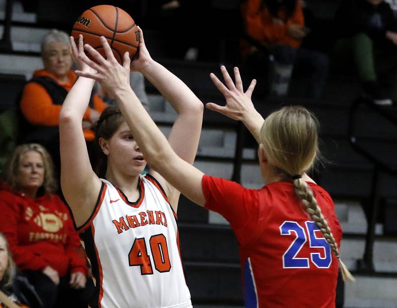 McHenry's Erin Nothdorf looks to pass as she is guarded by Monica Sierzputowski during a Fox Valley Conference girls basketball game on Tuesday, Dec. 12, 2023, at McHenry High School.