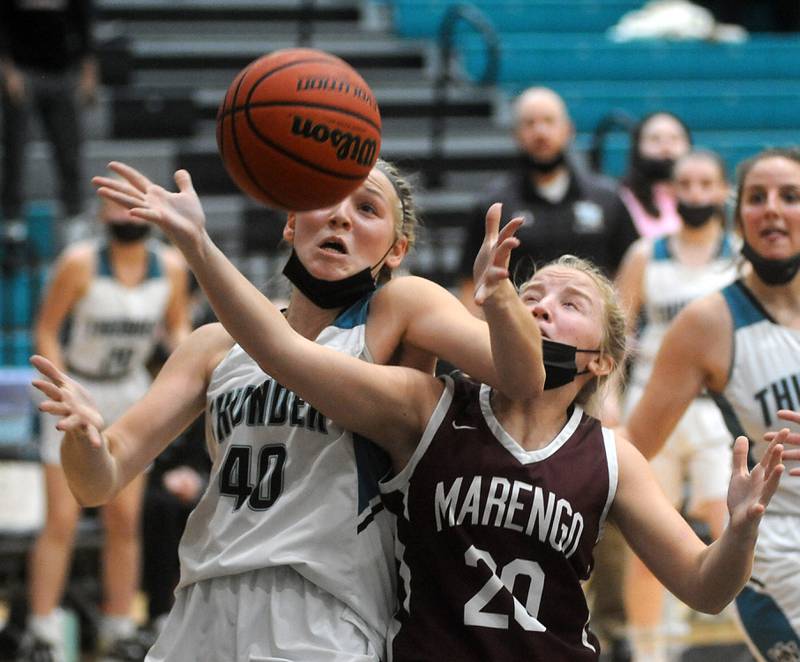 Woodstock North's Katelynn Ward and Marengo's Courtney Jasinski battle for the final rebound during the fourth quarter of a Kishwaukee River Conference girls basketball between Marengo and Woodstock North Wednesday evening, Jan. 12, 2022, at Woodstock North High School.
