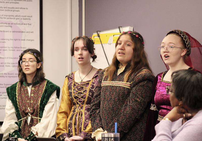 Dixon Public Schools board of education members Linda LeBlanc-Parks listens as members of the Dixon High School choral group gives a preview of the Madrigal dinner that will be 6:30 p.m. Friday at the high school gymnasium. Singers are, from left, Arin Newman, Anne McFarlane, Olivia Hernandez, and Grace DeBord.