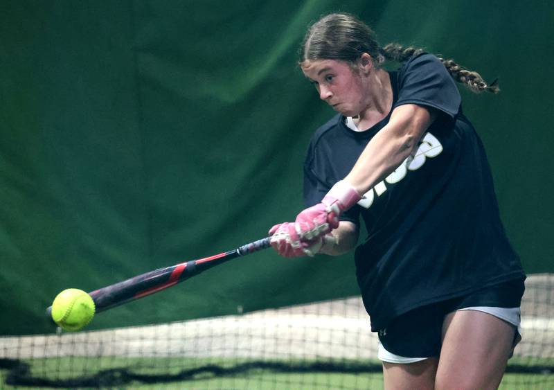 Sycamore Sycos 16u softball player Callie Countryman takes some swings in the batting cage Wednesday, June 18, 2025, at their indoor practice facility in DeKalb.