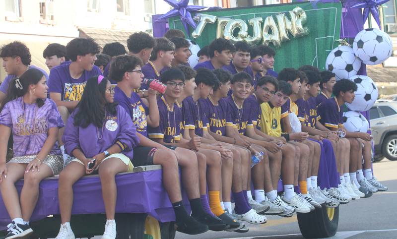 Members of the Mendota High School boys soccer team ride down Indiana Avenue during the homecoming parade on Friday, Oct. 3, 2025